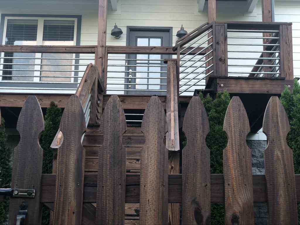 Photo of dark stained wood fence and deck